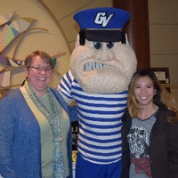 Two students taking picture with Louie
